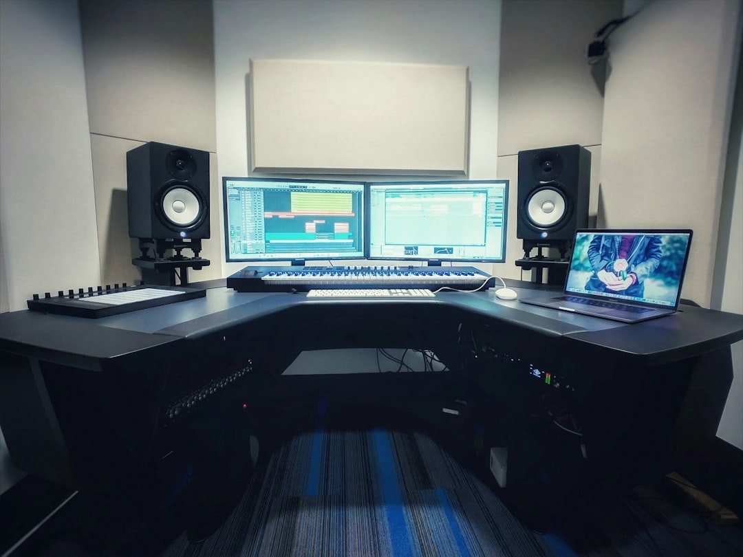 a-computer-desk-with-two-monitors-and-a-keyboard-xjk8gdwpxwk
